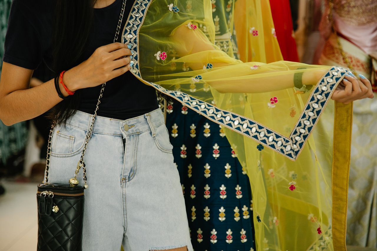 Crafting Captivating Headlines: Your awesome post title goes here Close-up of a woman holding a vibrant ethnic sheer fabric with traditional patterns.